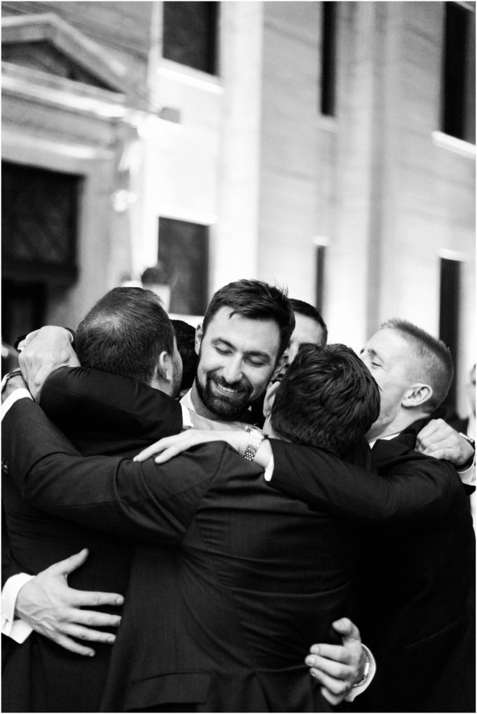 Ohio Statehouse reception groomsmen hugging